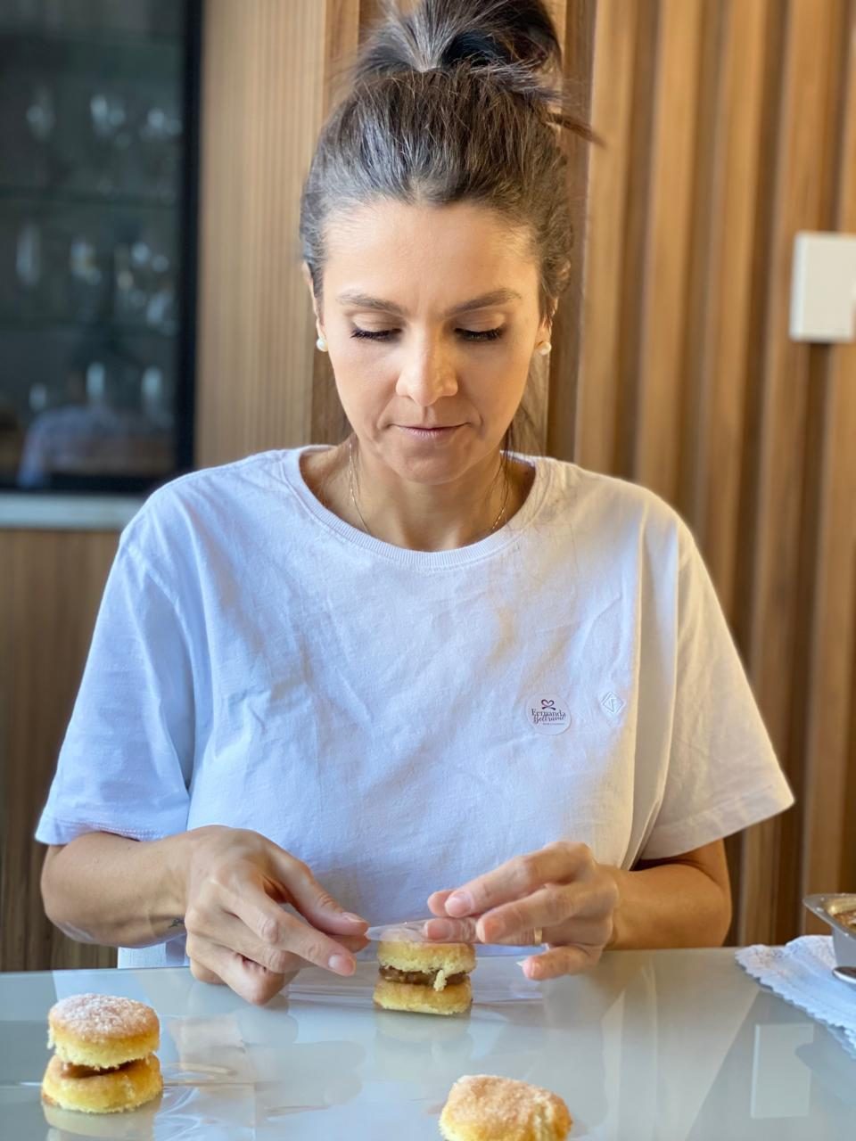Fernanda embrulhando um bem-casado no papel celofane